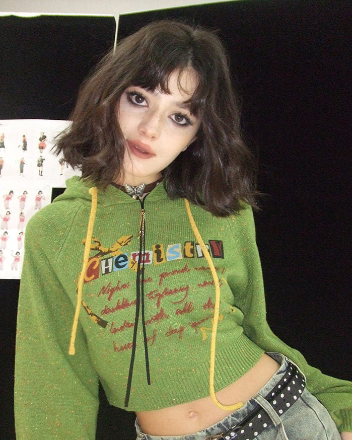 This preppy cropped hoodie in green features a cute 'Chemistry' print, ruffled collar details, and a knit construction