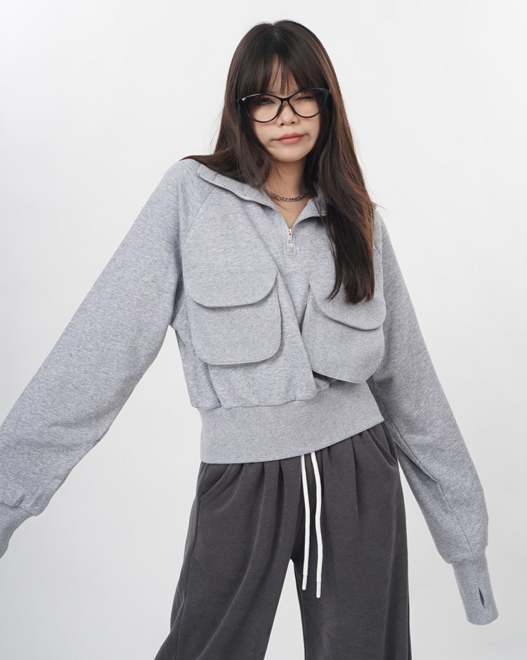 This grey zip-up sweatshirt features a cropped fit and big grey pockets in front. The very sweatshirt that Lisa from Blackpink wore in her special 27th Birthday vlog - Boogzel Clothing